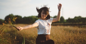 Woman in White and Brown Scoop Neck Dress in Brown Grass Field during Daytime