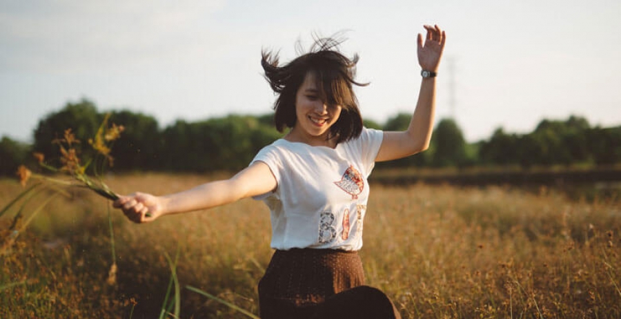 Woman in White and Brown Scoop Neck Dress in Brown Grass Field during Daytime